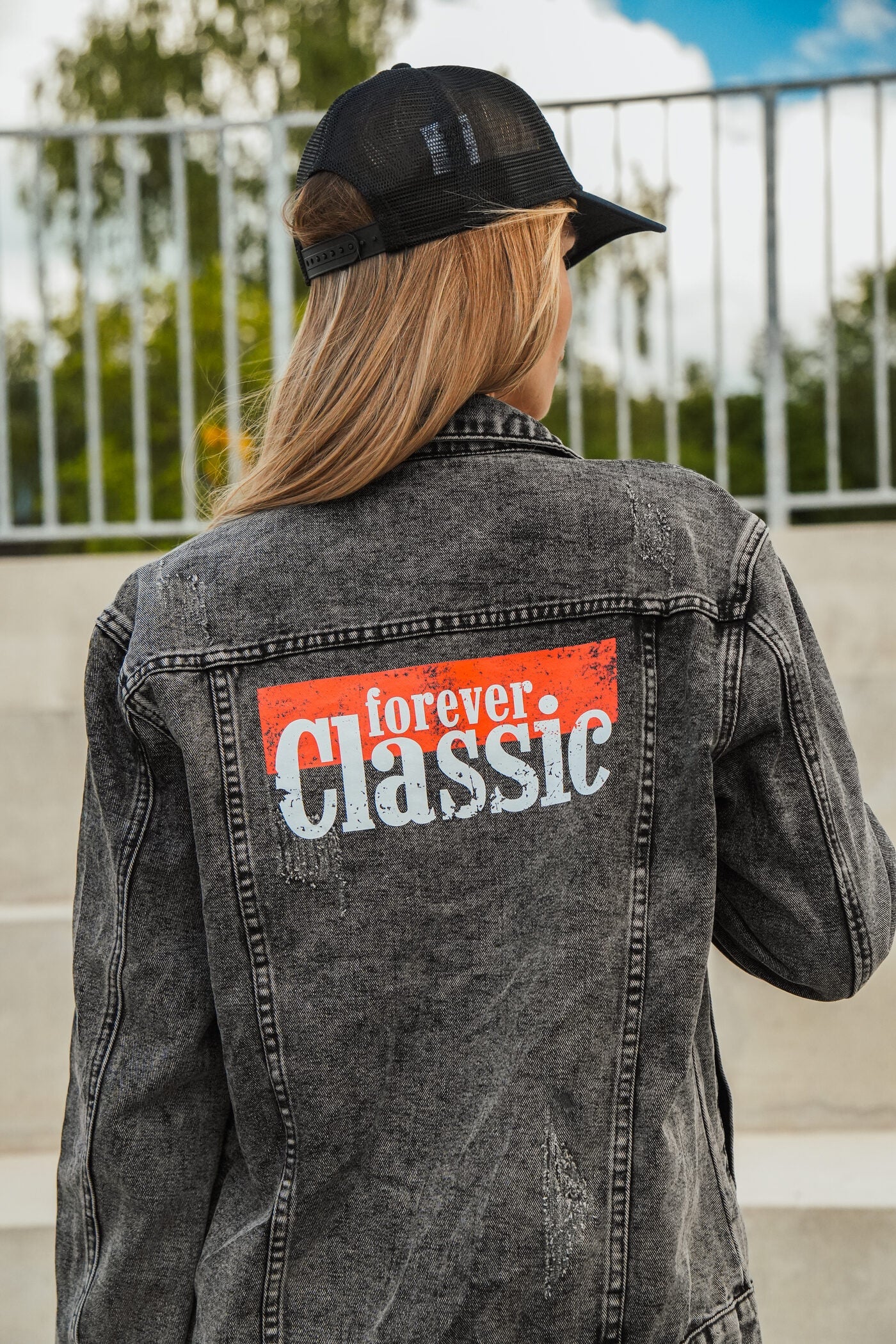 Forever Classic black unisex denim jacket with logo on front and back, button closure and pockets